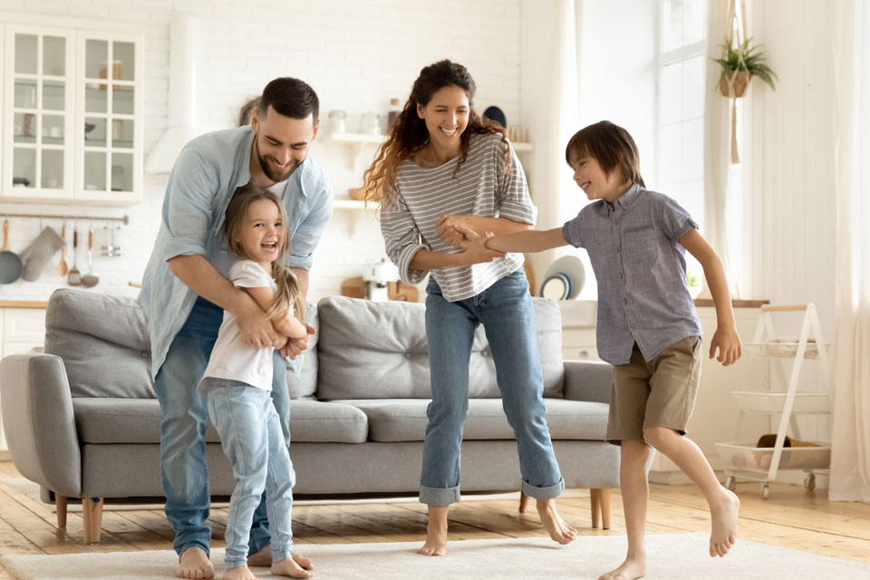 Family dancing in their living room